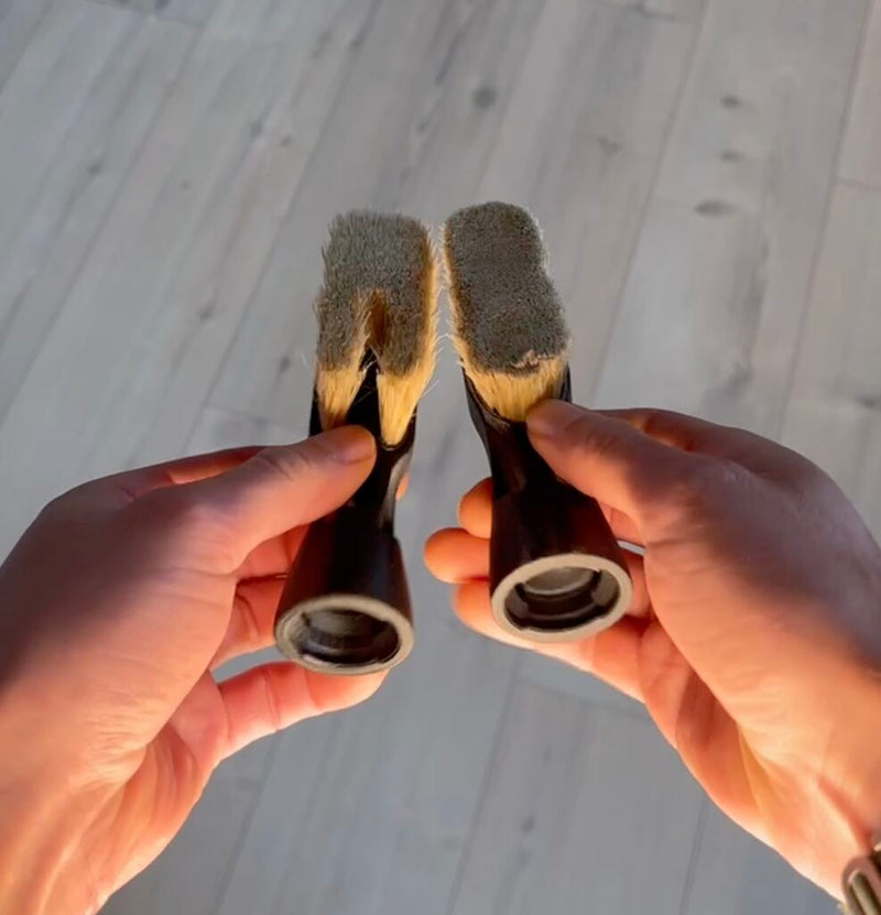 Two ChalkBlaster brush heads held side by side: V1 with bristles split by an air channel on the left, the simple symmetrical V2 insert on the right