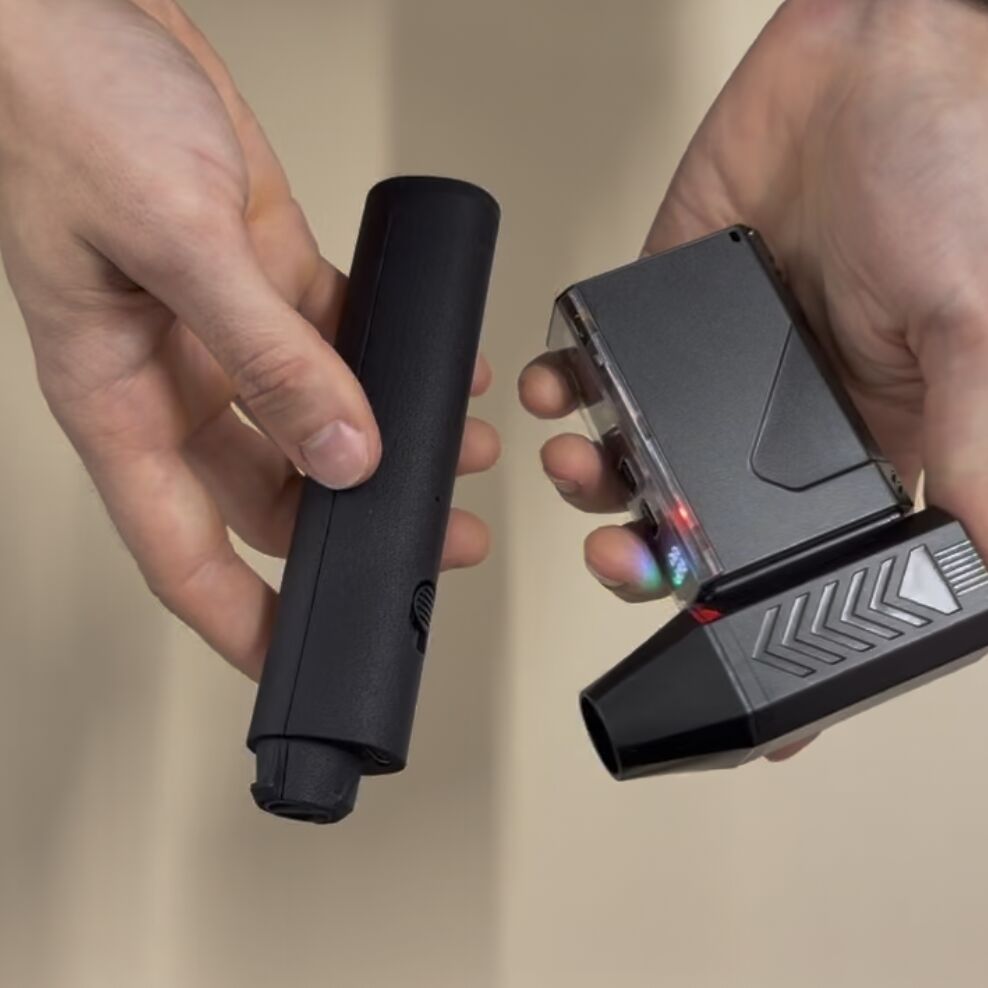 ChalkBlaster V2 I-shape handle held next to a T-shape handheld jet fan with the motor across the grip