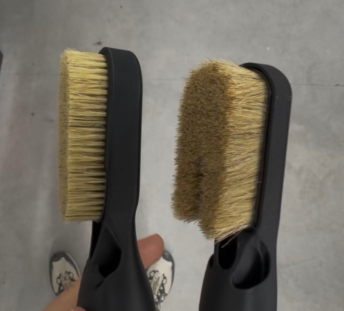 Two ChalkBlaster brush heads side by side: the industrial stapled-bristle insert on the left and the denser artisan pressed-bristle insert on the right