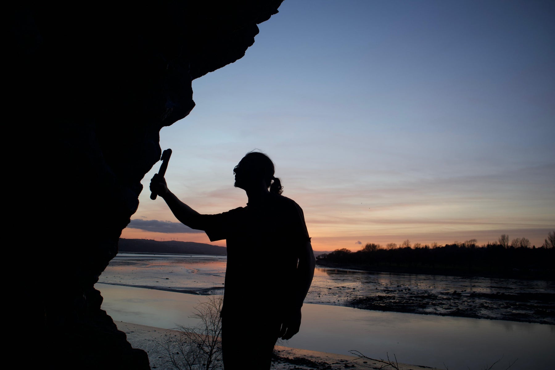 A climber brushing at sunset with the most innovative climbing brush of 2026. This is the perfect gift for the boulder who got everything. 