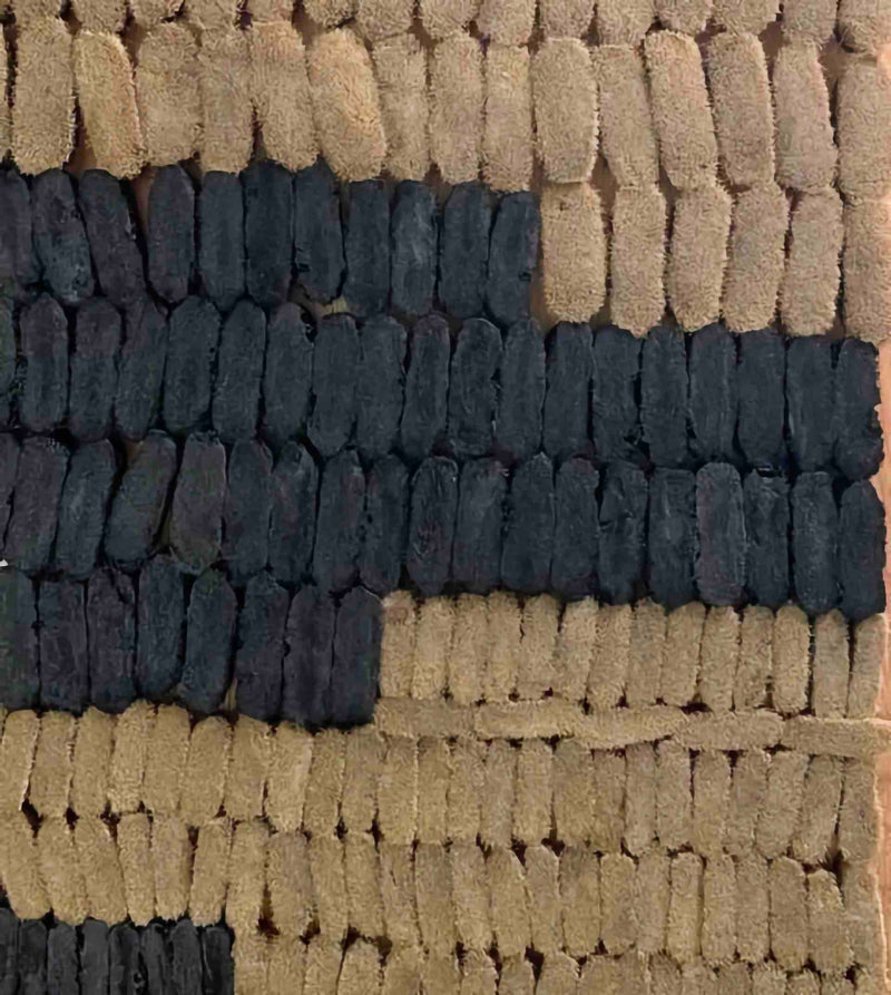 Rows of ChalkBlaster brush inserts laid out side by side, tan boar bristle inserts next to black nylon ones