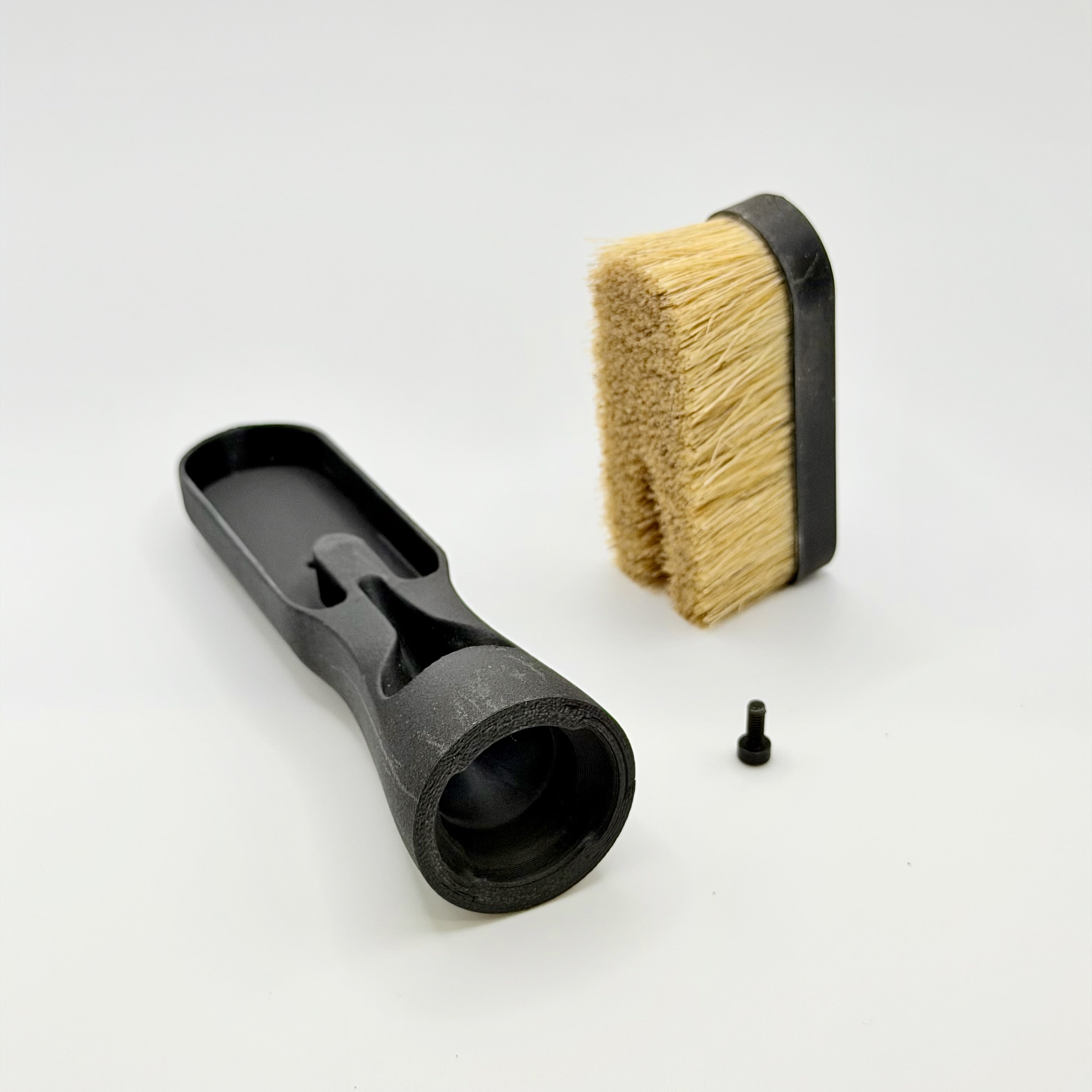 Showcase the Chalk Blaster brush head and its bristle with white background. The bristle can be taken off and inserted into the brush head with a single screw. 