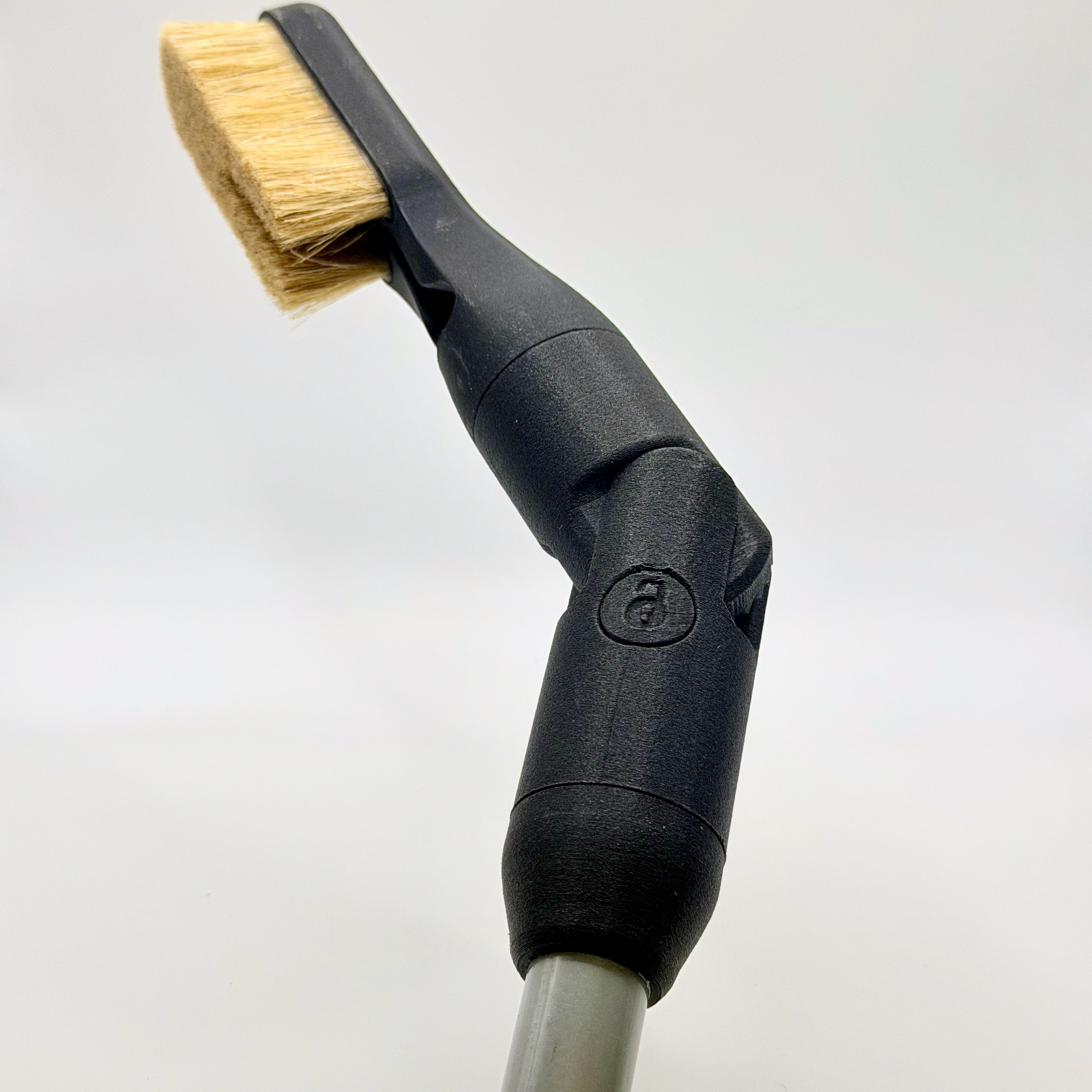 Extension attachment for the Chalk Blaster, a custom designed pivot mechanism that let air go through and brush climbing holds and rock far reached by a standard brush.